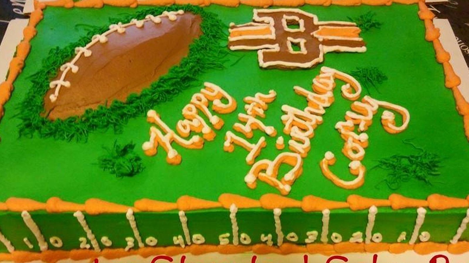 Cleveland Browns football-themed birthday cake by Cleveland Cake Boss, ready to light up a celebration